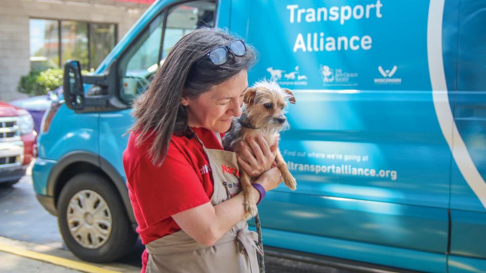 Woman holding AHS transport dog